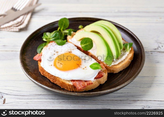 toast with fried egg on a wooden table. toast with fried egg