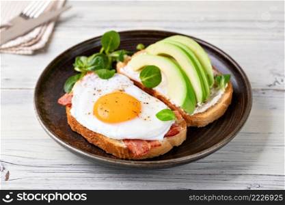 toast with fried egg on a wooden table. toast with fried egg