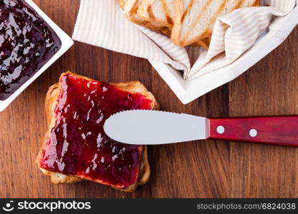 Toast with jam. Toast with jam on a wooden table