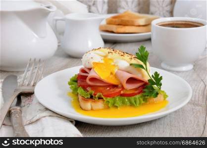 Toast with slices of ham and tomatoes, Benedict egg with Dutch sauce for Breakfast