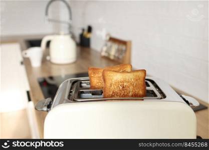 toasted grain bread in white toaster, roasted sandwich toast, concept of healthy eating, dieting, snacking at work, at school, student fast food. Modern white toaster. toasted bread in white toaster, roasted sandwich toast, concept of healthy eating, dieting, snacking at work, at school, student fast food. Modern white toaster.