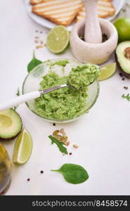 Toasts preparation - Mashed avocados in a glass bowl.. Toasts preparation - Mashed avocados in a glass bowl