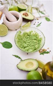 Toasts preparation - Mashed avocados in a glass bowl.. Toasts preparation - Mashed avocados in a glass bowl