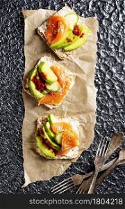 toasts with avocado and fresh salmon fish