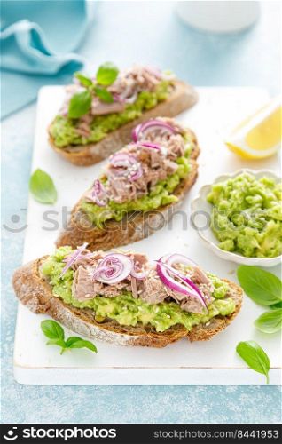 Toasts with canned tuna and avocado guacamole. Healthy food, diet breakfast