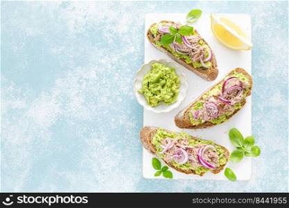 Toasts with canned tuna and avocado guacamole. Healthy food, diet breakfast