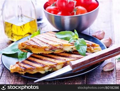 toasts with cheese and ham on the plate