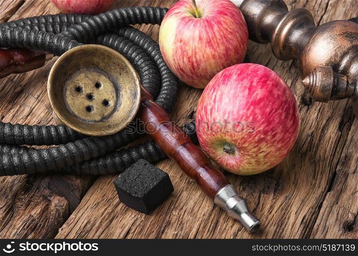 Tobacco hookah on apple tobacco. Oriental smoking hookah with the aroma of autumn apples