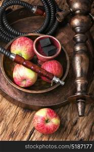 Tobacco hookah on apple tobacco. Oriental smoking hookah with the aroma of autumn apples