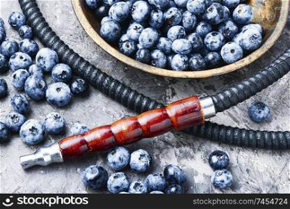 Tobacco hookah.Shisha mouthpiece and parts for the smoking hookah.Kalian with blueberries.Berry hookah taste.. Tobacco hookah with bilberry