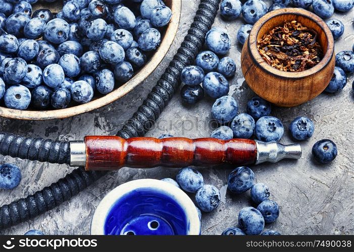Tobacco hookah.Shisha mouthpiece and parts for the smoking hookah.Kalian with blueberries.Berry hookah. Arabia shisha with blueberry tobacco