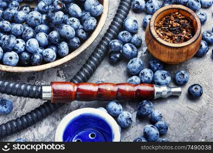 Tobacco hookah.Shisha mouthpiece and parts for the smoking hookah.Kalian with blueberries.Berry hookah. Arabia shisha with blueberry tobacco