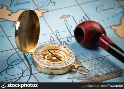 tobacco pipe and a compass on the map
