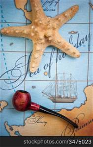 tobacco pipe and a starfish on a stylized map