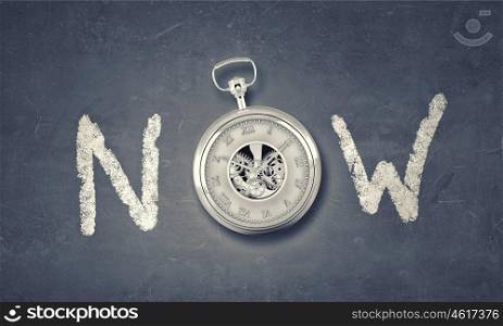 Today and now. Conceptual image with word now and pocket watch instead of letter