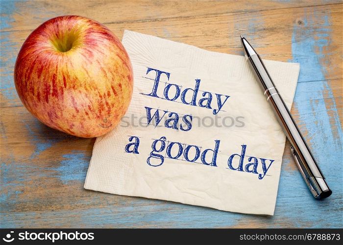 Today was a good day positive affirmation - handwriting on a napkin with a fresh apple