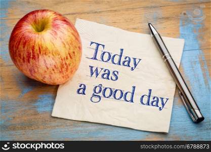 Today was a good day positive affirmation - handwriting on a napkin with a fresh apple