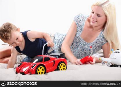Toddler and mum playing with a remote controlled sports car