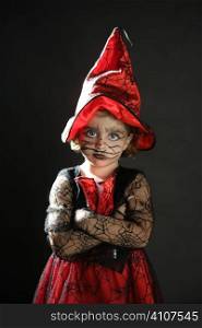 Toddler beautiful witch girl wearing halloween costume and make up