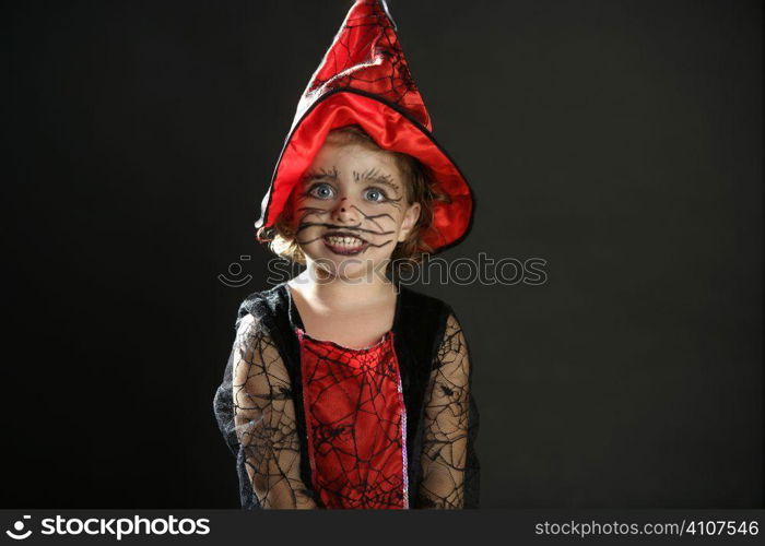Toddler beautiful witch girl wearing halloween costume and make up