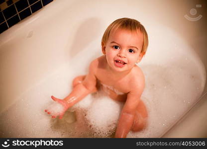 Toddler boy having a bath