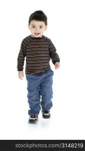 Toddler boy in long sleeves and jeans walking over white.