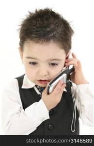Toddler boy in suit speaking on cellphone. Concerned expression. Shot in studio over white.