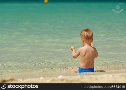 Toddler boy on beach . Two year old toddler boy on beach