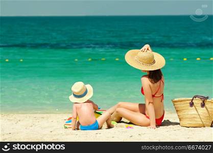Toddler boy on beach with mother . Two year old toddler boy on beach with mother