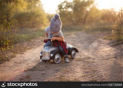 Toddler driving toy car outdoors