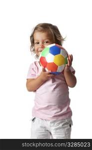 Toddler girl playing with a colored ball on white background