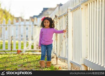 Toddler kid girl portrait in a park fence latin ethnicity