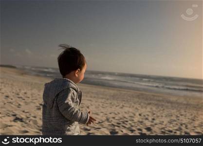 Toddler on the beach. Toddler having great fun on the beach