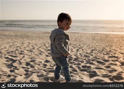 Toddler on the beach. Toddler having great fun on the beach