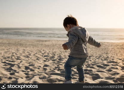 Toddler on the beach. Toddler having great fun on the beach