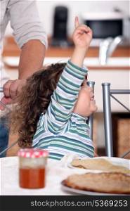 toddler raising arm to ask for permission