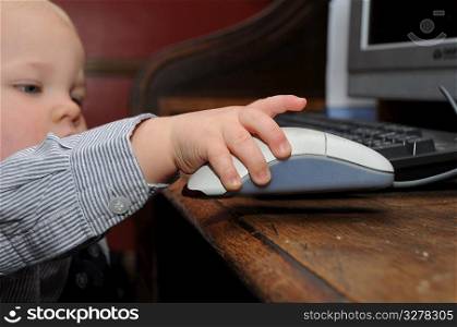 Toddler with a computer mouse.