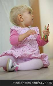 Toddler with colorful crayons