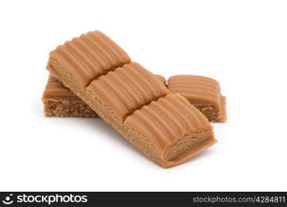 toffee in plate on white background