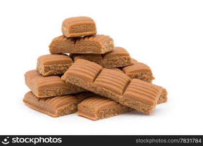 toffee in plate on white background