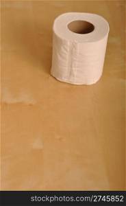 toilet paper roll on brown wooden background