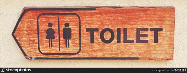 toilet plate sign on orange wall