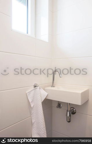 Toilet sink interior white bathroom, faucet with white wall wit h white towel. Toilet sink interior white bathroom, faucet with white wall