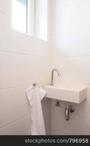 Toilet sink interior white bathroom, faucet with white wall wit h white towel. Toilet sink interior white bathroom, faucet with white wall