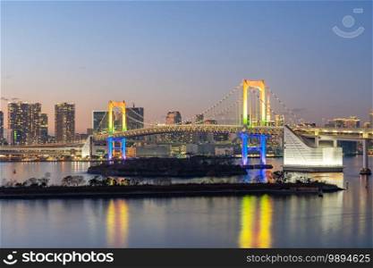 Tokyo bay at night with Rainbow bridge in Tokyo, Japan.