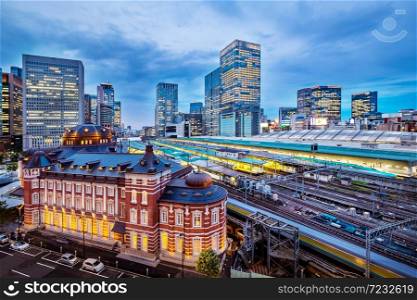 Tokyo city skyline at railway station surround by modern highrise building at twilight time. Tokyo city, Japan.. Tokyo city skyline at railway station surround by modern highrise building at twilight time.
