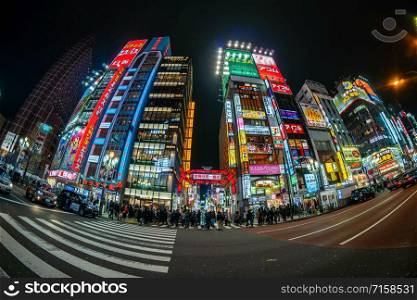 TOKYO, JAPAN - FEB 2019 : Fisheye Scene of Kabukicho which is one Shopping neon street of shinjuku area with crowds undefined people walking at night time on Febuary 15, 2019 in Tokyo, Japan.