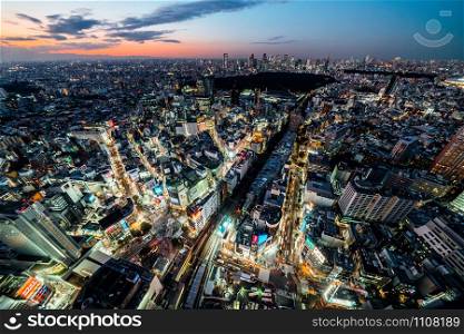 Tokyo, Japan - Nov 5, 2019: Shibuya scramble crossing cityscape landscape, car traffic transport and crowded people walk. High angle view. Asia tourist attraction, Japan tourism, Asian city concept