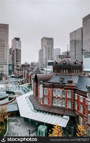 Tokyo Station old heritage red brick building Marunouchi district with modern office towers in background
