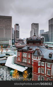 Tokyo Station old heritage red brick building Marunouchi district with modern office towers in background